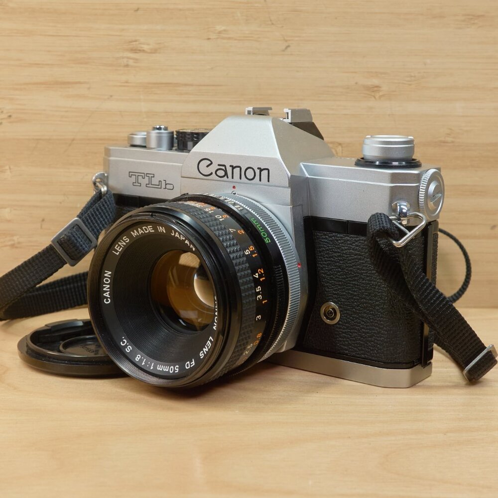 Canon silver and black SLR Film Camera with 50mm Lens